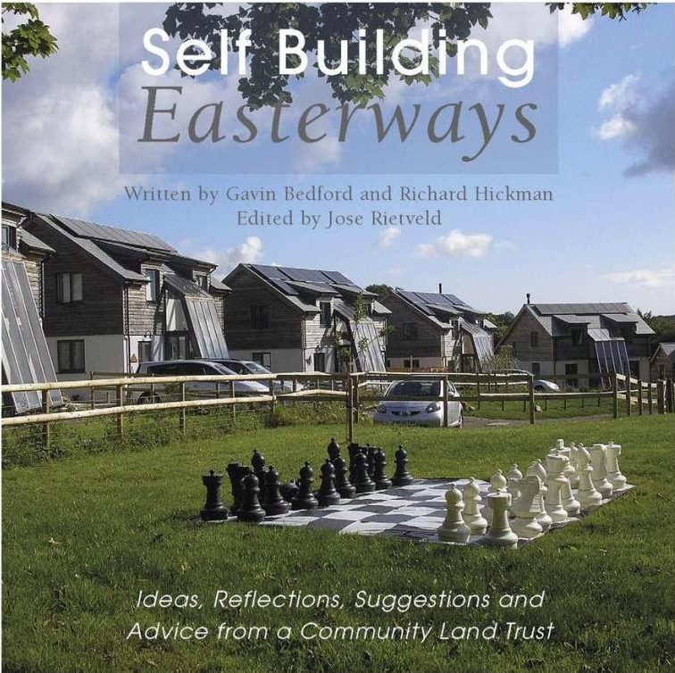 Front cover of as book called Self building Easterways. Shows a giant outdoor chess set in front of a row of detached houses